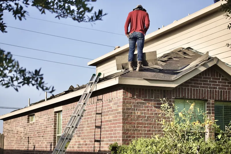 Professional roofer working on a residential roof in Pecan Park